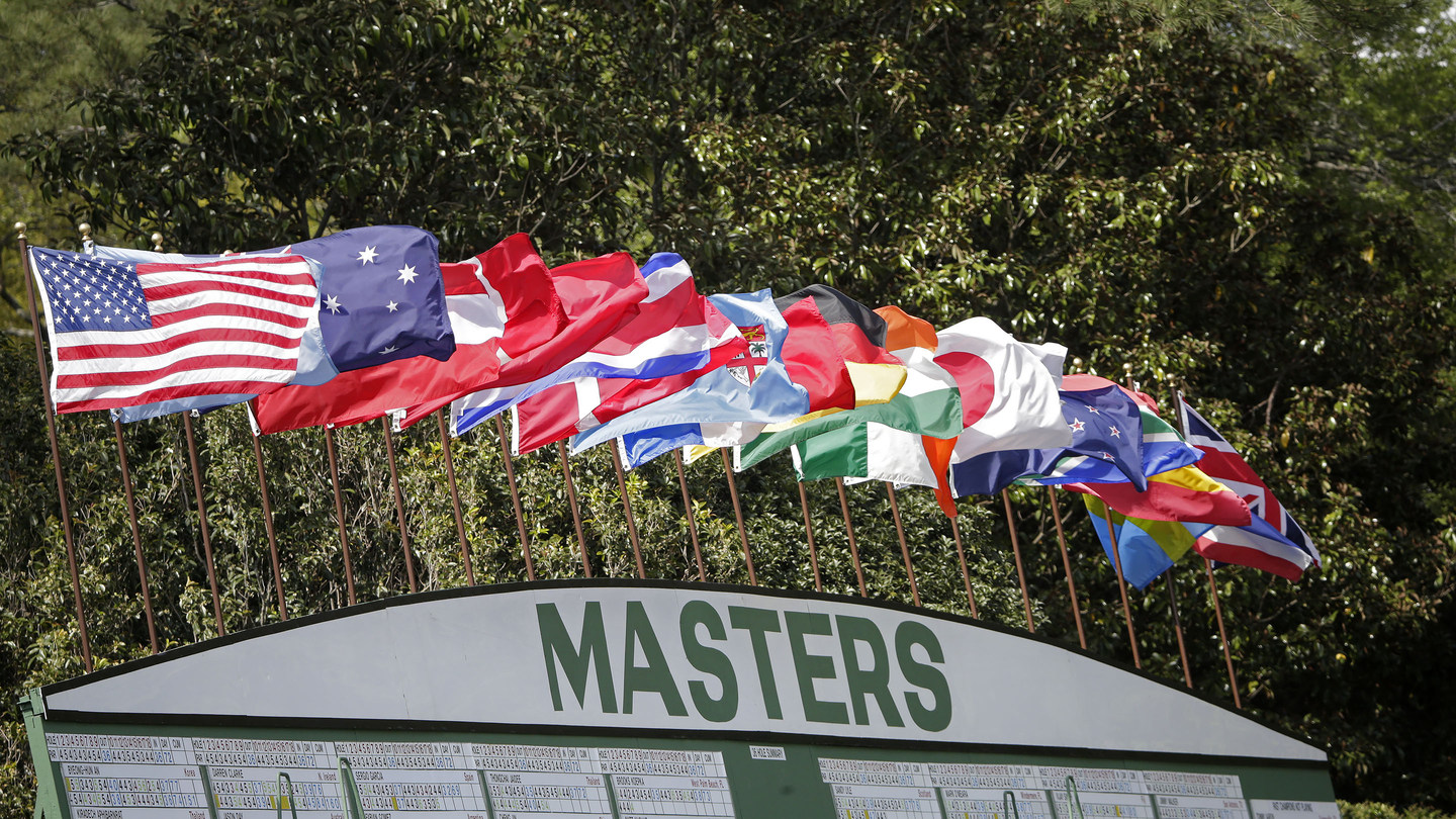 Flags fly above the Main Score board during Round 2 at Augusta National Golf Club on Friday April 8, 2016.